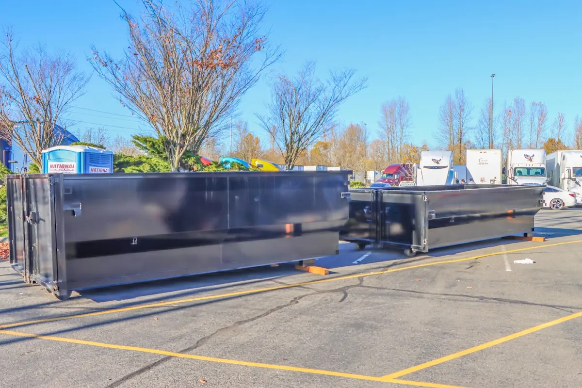 Professional dumpster rental service with roll-off container on residential driveway in Moultonborough